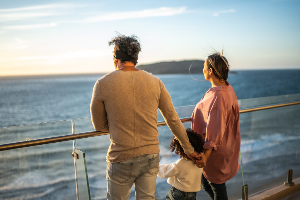 Family looking to the landscape during a cruise travel - Sharon Carr Travel