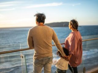 Family looking to the landscape during a cruise travel - Sharon Carr Travel