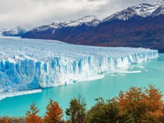 Chilean Fjords with mountains in the background and blue water - Sharon Carr Travel