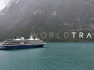 Cruise ship sailing past mountain - Sharon Carr Travel