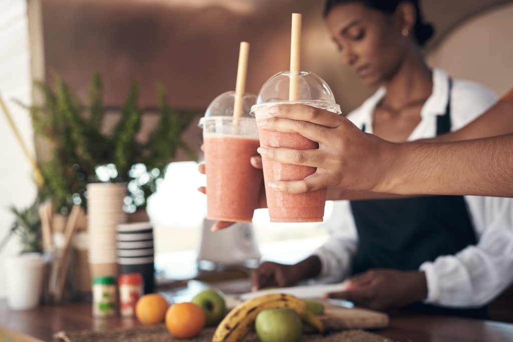 giving a customer their smoothies - Sharon Carr Travel
