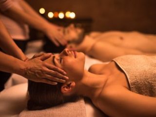 Couple relaxing at the spa during facial massage - Sharon Carr Travel, Dallas