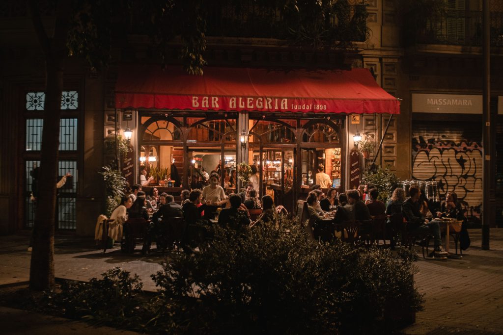 Tourists dining at Bar Alegria at night - Sharon Carr Travel