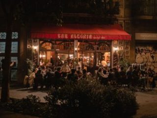 Tourists dining at Bar Alegria at night - Sharon Carr Travel