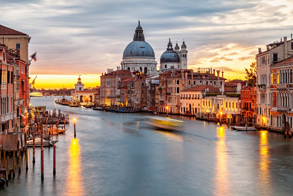 Sunrise view of Grand Canal traffic and Basilica di Santa Maria della Salute, Venice, Italy - Sharon Carr Travel