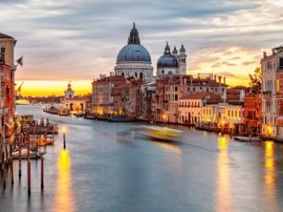 Sunrise view of Grand Canal traffic and Basilica di Santa Maria della Salute, Venice, Italy - Sharon Carr Travel